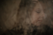 portrait of a woman through frosted glass