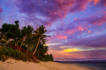 pink and purple clouds over a beach at sunset