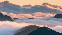 Time lapse of morning clouds in wild mountains of New Zealand landscape at sunrise. 
