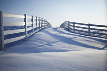 snow and white fence line
