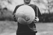 child holding a soccer ball 