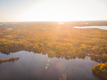 aerial view over a lake and swamp in fall 
