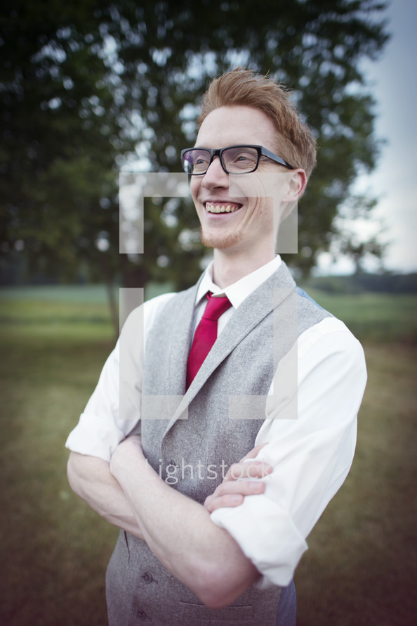 man in vest and tie and reading glasses 