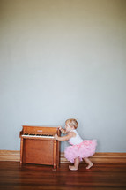 toddler girl and a piano 