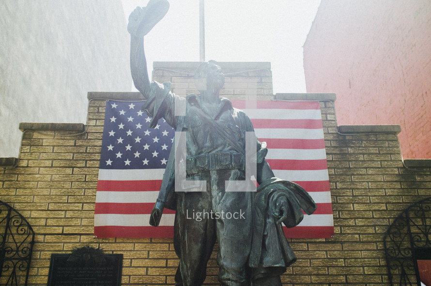 Statue and an American flag