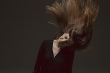 A woman tossing her hair 