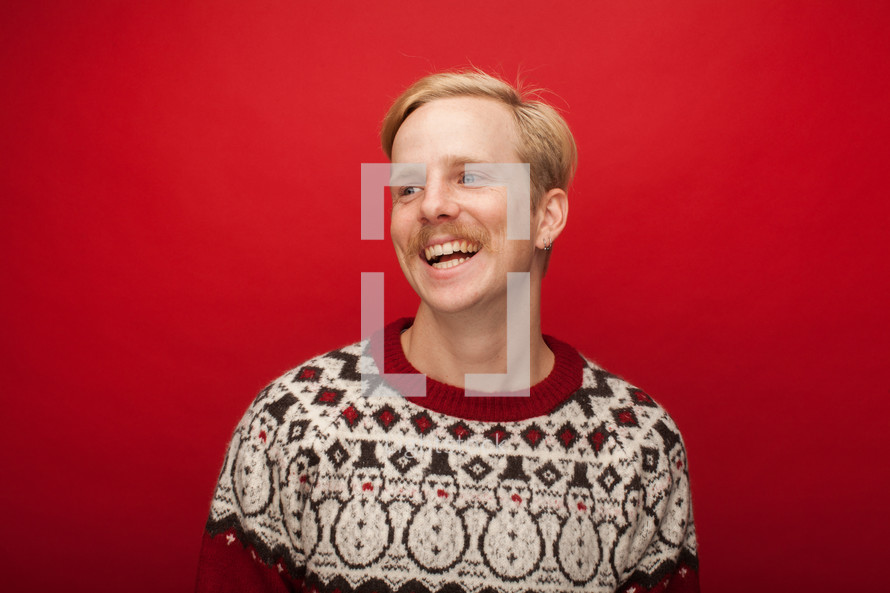 a man with a mustache in a Christmas sweater 