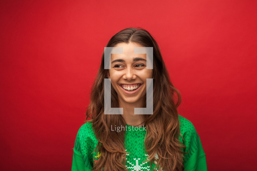 headshot of a smiling woman in a Christmas shirt 