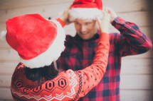 a couple wearing Santa hats 