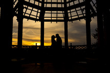 silhouette couple kissing at sunset 