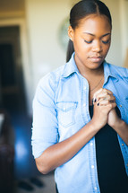 Standing woman praying.
