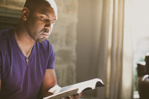 African-American man reading a Bible 
