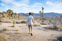 A man walking in a desert.