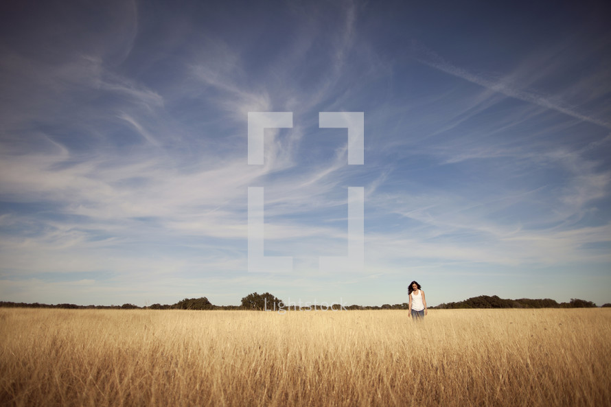Woman on dry wheat field 