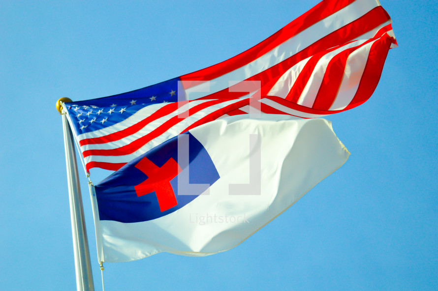 American and Christian flag against a blue sky 