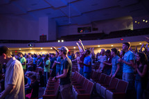 congregation with raised hands at a worship service 