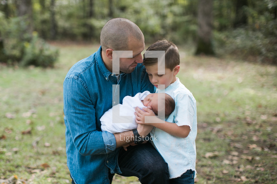 father, son, and newborn baby