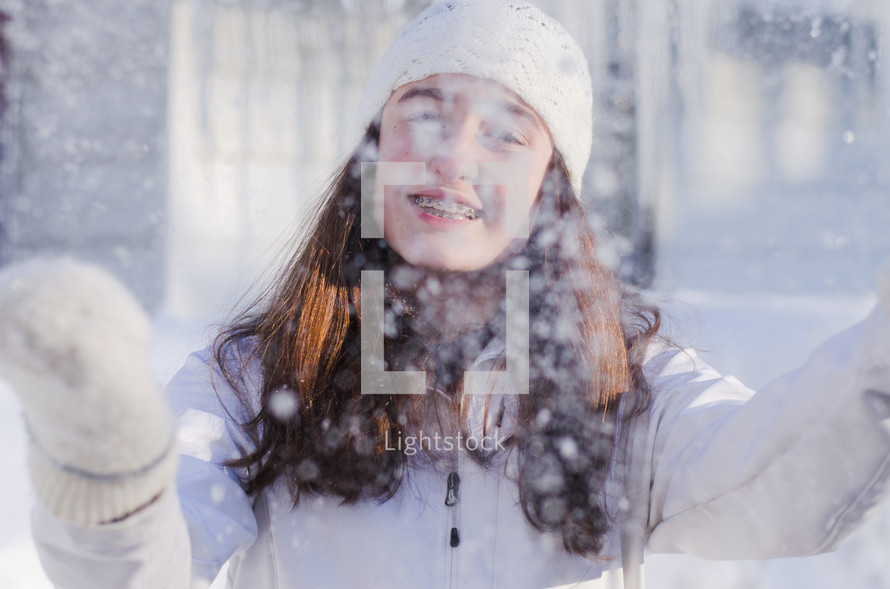 teen girl with braces in falling snow 