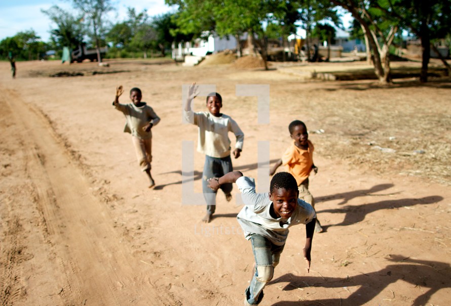 children chasing after a moving vehicle 