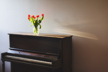 tulips on piano in evening light