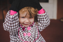 a toddler girl bundled up for chilly weather 