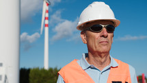 Construction site manager checks the correct installation of the wind turbines