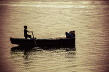 a child rowing a fishing boat 