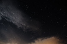 clouds and stars in the night sky 