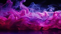 
Abstract pink and purple smoke on a black background. Copy space.
