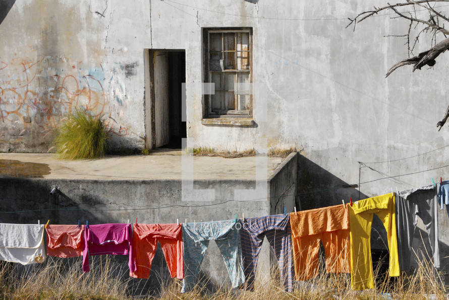 clothes on the line in front of an old building