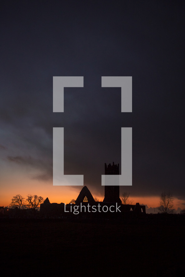 silhouette of church ruins at sunset 