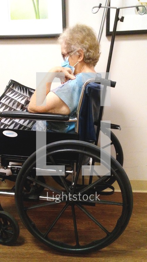 An elderly woman with white hair in a wheelchair wearing a face mask awaiting help from a Doctor or Nurse at a hospital. The year of Covid-19 has taken its toll on nursing homes across the country as CNA's, Nurses and health care professionals get sick from COVID-19 and endanger the lives of the elderly causing shutdowns, isolation, loneliness and separation from loved ones as well as a devastation to the United States Economy. While sickness, fear, poverty make headline news, people forget that the Lord is still in control over their lives, their wealth, their health and their eternal reward in Heaven. COVID-19 may be the buzzword for the year 2020 but it is not the final word on our future as Christ holds the future in His hands, even when we are old and gray.
