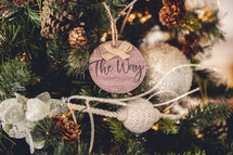 Wooden ornament with the word "the way" on a Christmas tree 
