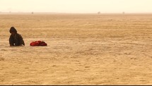 toddler playing in desert sand 