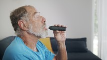 Man with Parkinson's disease using medical Cannabis in vaporizer to stop shaking