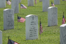 American flags and grave markers in a cemetery
