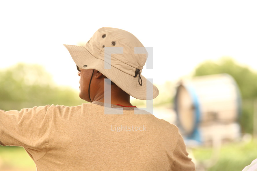 a man in a safari hat pointing 