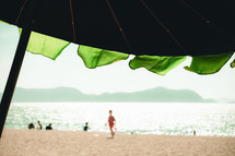 beach umbrella and kids on a beach 