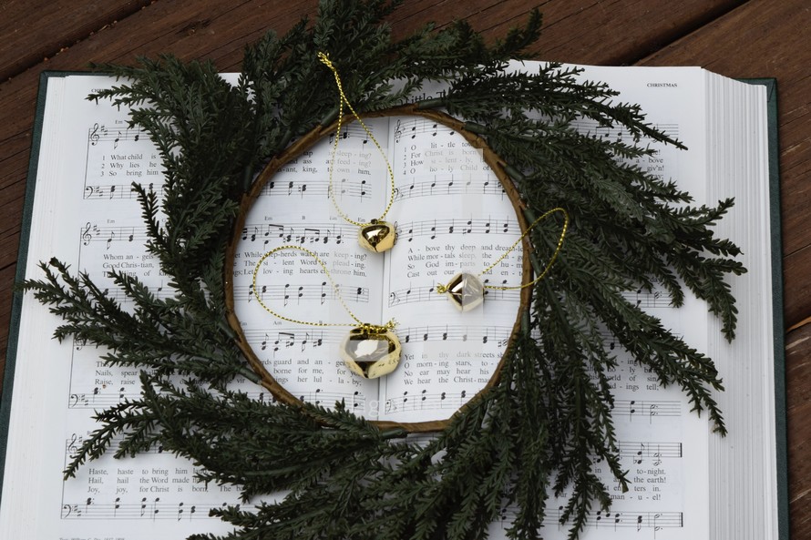 hymnal with bells and wreath 