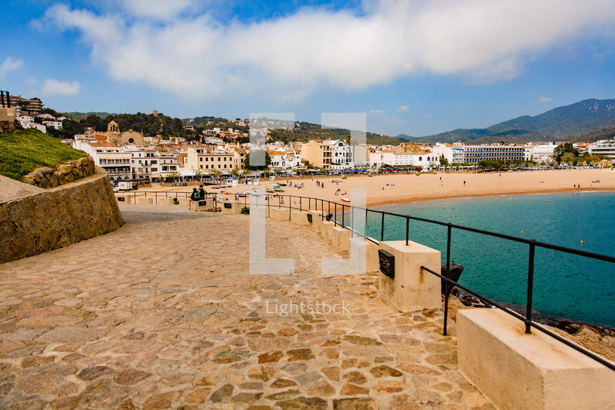stone walkway beside a beach in Spain 