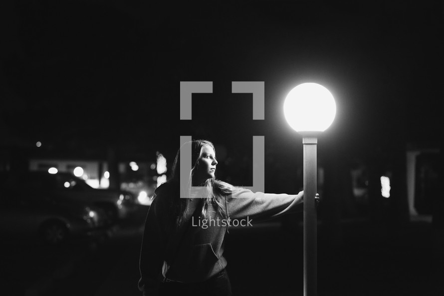 a young girl by street lamp