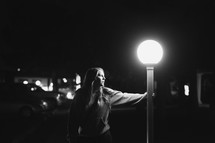 a young girl by street lamp