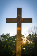 sunburst behind a cross (vertical)
