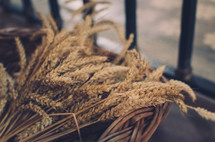 a basket with a sheaf of wheat