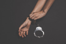 a woman taking off handcuffs 