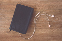A Bible and earbuds 