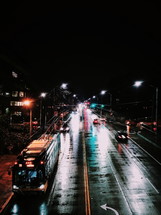 public bus on wet roads at night 