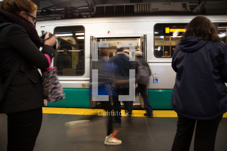 people boarding a subway train 