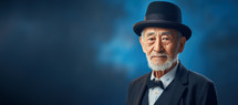Close-up portrait of a wise old asian man with hat. Grandfather or senior concept.