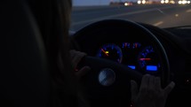 A woman driving at dusk